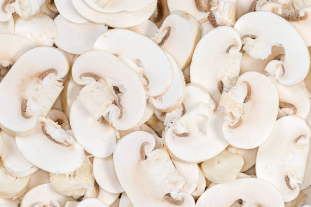 istock Background of the daw sliced button mushrooms, top view 1994838663
