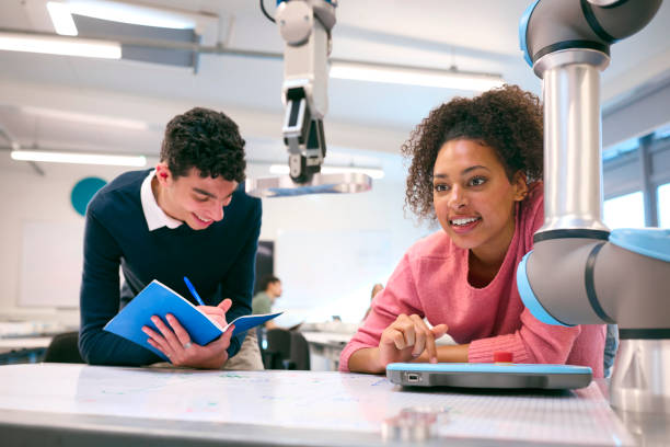 istock Male And Female College Or University Engineering Students In Robotics Class Working Together 1994840535
