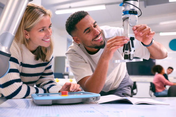 istock Male And Female College Or University Engineering Students In Robotics Class Working Together 1994849197