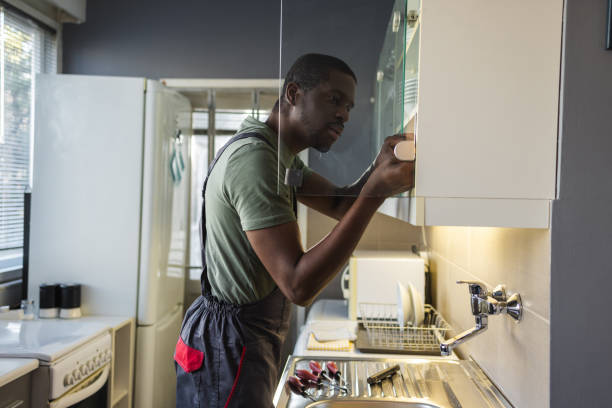 istock Handyman is repairing the kitchen unit 1994867371