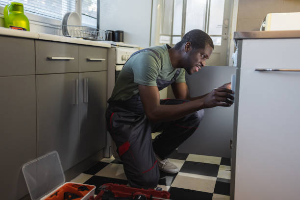 istock Male plumber repairs a broken water pipe under the sink 1994870680