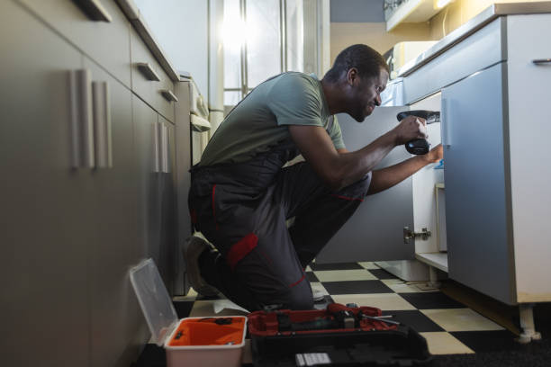 istock The plumber fixing the sink in the kitchen 1994878868