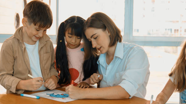 istock Happy student and smart teacher drawing and coloring by using marker. Erudition. 1994885285