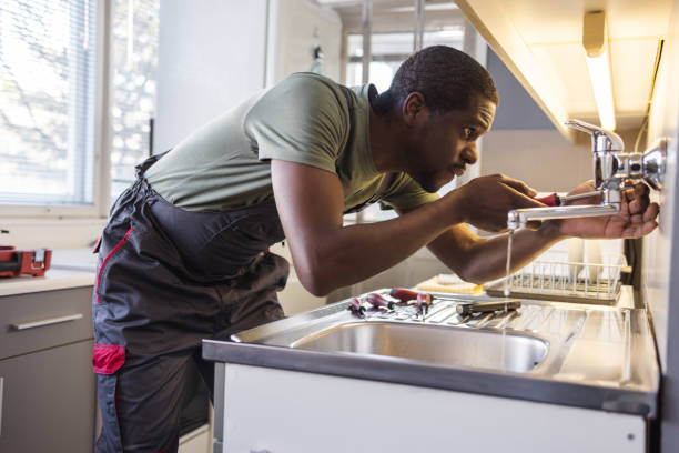 istock African American plumber carefully fixes a leak in a sink 1994886964