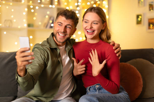 istock Couple taking selfie during romantic proposal at home 1994892381