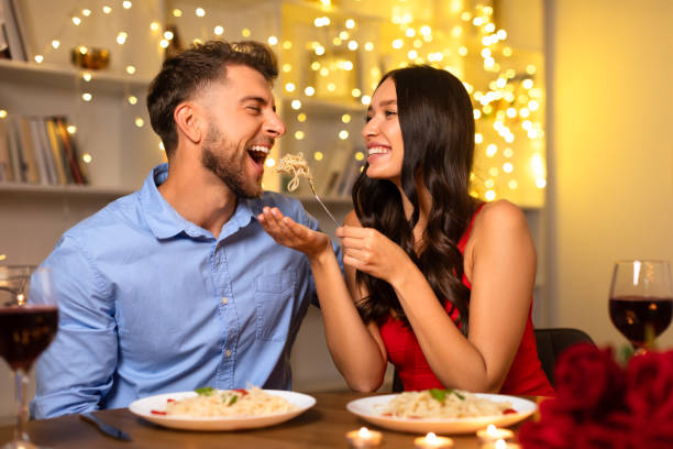 istock Couple sharing a playful moment with pasta during romantic dinner 1994893539