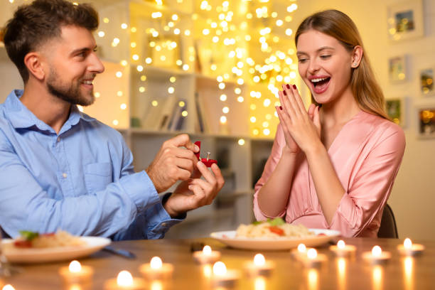 istock Ecstatic woman reacting to a marriage proposal at a candlelit dinner 1994893981