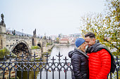 Young Tourists standing on the Charles Bridge and exploring the city