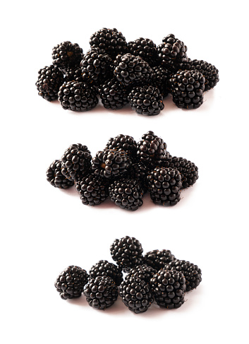 Blackberries isolated on white background. Heap of blackberries on white background.