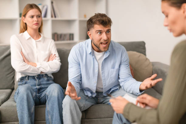 istock Aggressive husband shouts in anger during tense therapy session indoor 1994911868