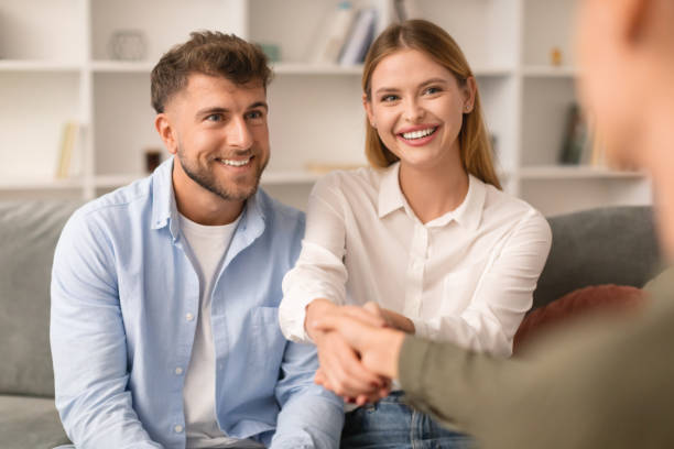 istock Grateful husband and wife shaking hands with therapist at office 1994912386