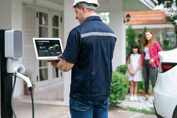 istock Qualified technician working with laptop for home EV station. Synchronos 1994914582