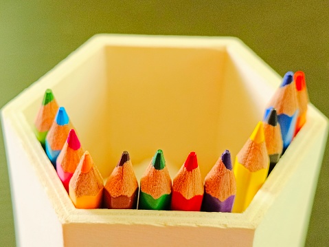 Defocused view of colour pencils in a wooden box