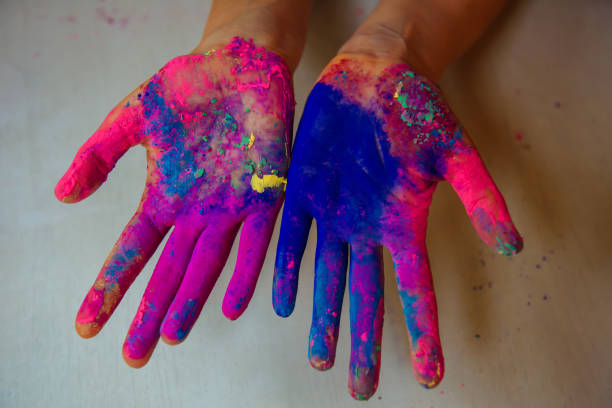 istock Women's palms covered with bright dry Holi paint. Hands covered in dry paint 1994966882