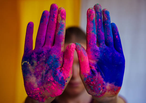 istock Women's palms covered with bright dry Holi paint. Hands covered in dry paint 1994966889