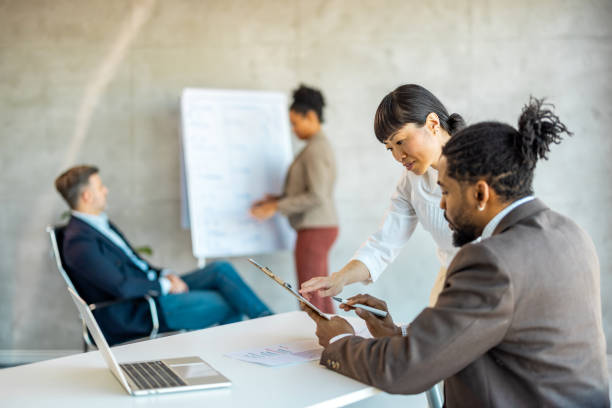 istock A businessman having presentation with colleagues about project he working on at the office. 1994967432