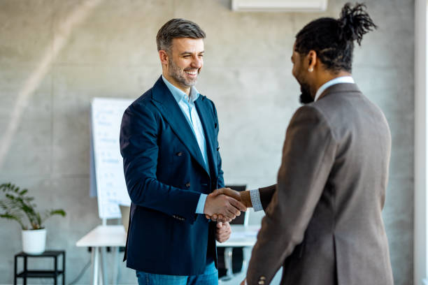 istock Two businessmen shaking hands in an office 1994970133