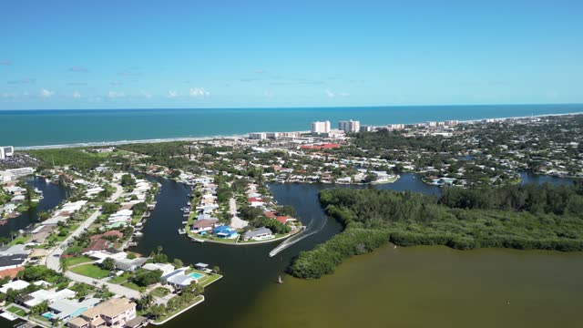 Flying over a Cocoa Beach residential neighborhood near Thousand Islands Conservation Area in the Indian River Lagoon in Brevard County, Florida.