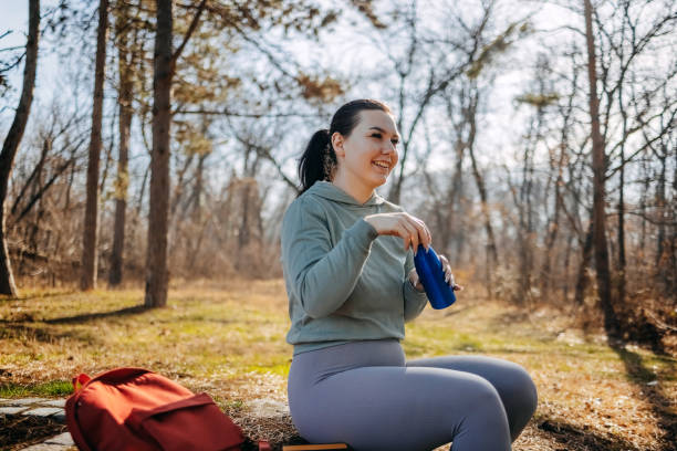 istock Single person having quality time enjoying in nature at spring holding water bottle 1995001727
