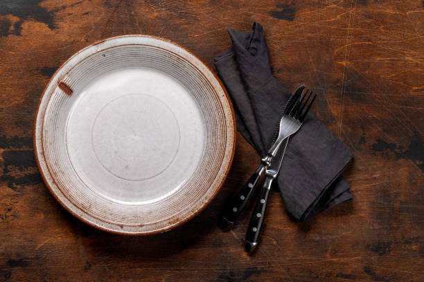istock Mockup for a delicious meal. Empty plate on a table 1995003659