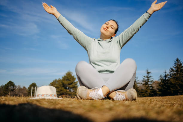 Young woman living healthy lifestyle enjoying fresh air and feeling connection with nature