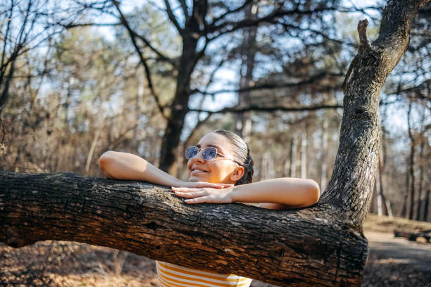 Young woman living healthy lifestyle enjoying fresh air and feeling connection with nature