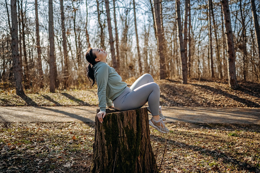 Young woman living healthy lifestyle enjoying fresh air and feeling connection with nature