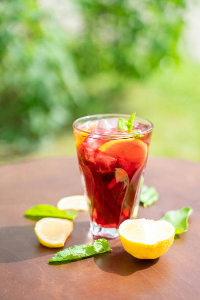 istock glass with fresh spring or summer iced drink mocktail with lemon and mint at table in caffe in day light 1995019107