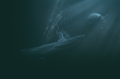 A World War II era U-Boat submarine navigating the depths of an ocean, passing perilously close to an old-fashioned contact sea mine.