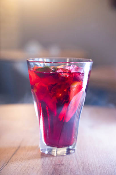 istock glass with fresh spring or summer iced drink mocktail with lemon and mint at table in caffe in evening light 1995034996