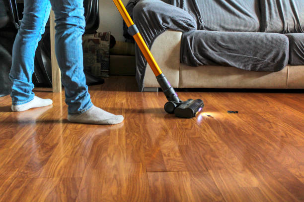istock Man vacuuming the living room floor 1995039313