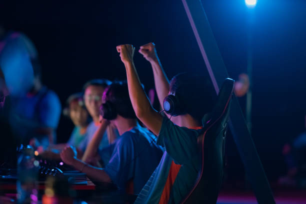Asian male esport player won hand gesture