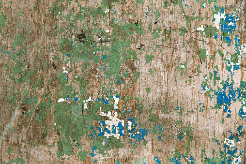 Old wood texture background, vintage wood background with remnants of coating, peeling blue and green paint