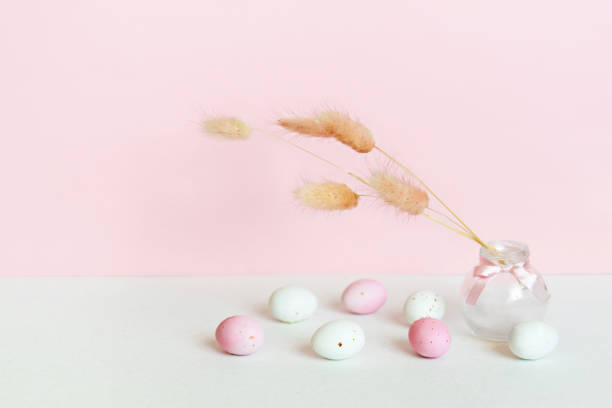 istock Easter minimalistic concept with easter eggs and a bouquet of dried flowers. Delicate pastel empty background with copy space. 1995047693