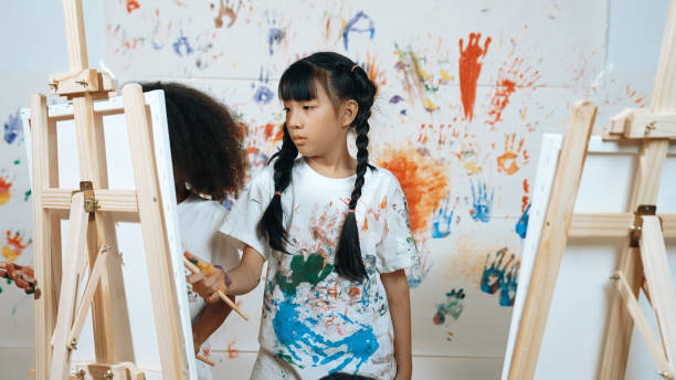istock Student painted or draw canvas with diverse friends in art lesson. Erudition. 1995051972