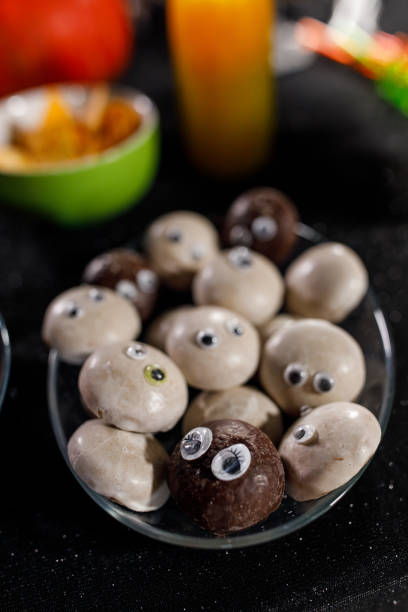 istock White and dark chocolate cookies with googly eyes 1995070817