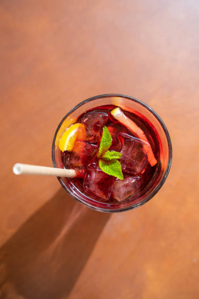 istock glass with fresh spring or summer iced drink mocktail with lemon and mint at table in caffe terrace flat lay 1995081278