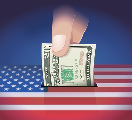 Background in the colors of the United States flag in which a hand places a 20 dollar bill in a slot like a ballot box or piggy bank