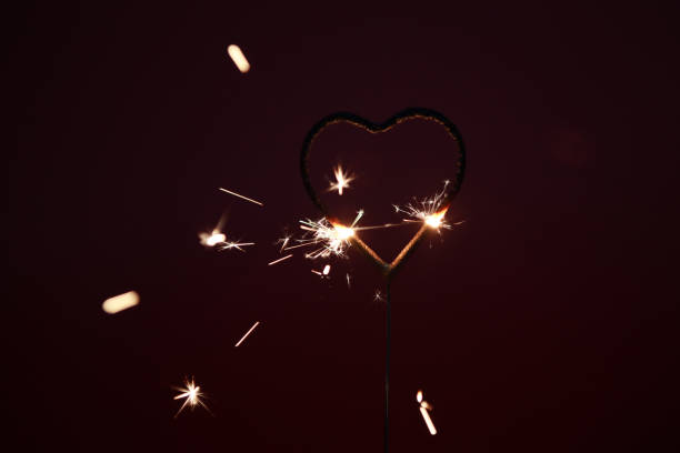 istock Fireworks spark at high speed with a black background, and Burning sparklers with many beautiful sparks on a black background. Concept of New Year or birthday celebration 1995112970