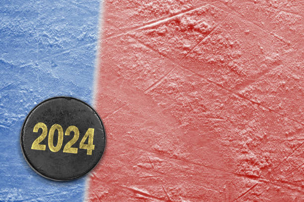 istock Hockey puck on red and blue ice 1995121408