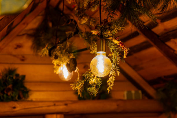 istock a rustic wooden hut with a glowing light bulb 1995132786