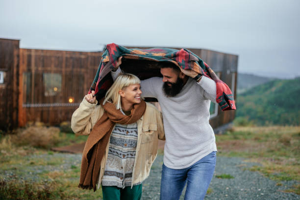 istock Cheerful couple walking in rain. 1995133889