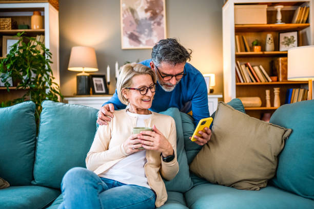 istock Mature couple using mobile phone 1995135650