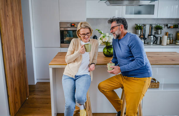istock Mature couple drinking coffee together in the kitchen 1995140610