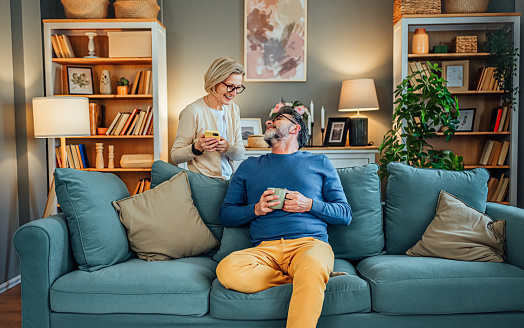 Smiling mature couple enjoying spending time together at home