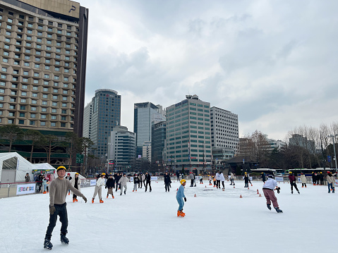 Seoul, Korea - Febrary 7th 2024, Many Kids enjoy skating at Seoul Plaza near Deoksugung Palace and Seoul City Hall in Downtown Seoul Korea. 서울