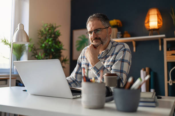 istock Mature Caucasian man working at his home office 1995148929
