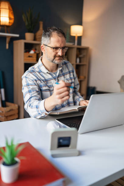 Mature Caucasian man working at his home office