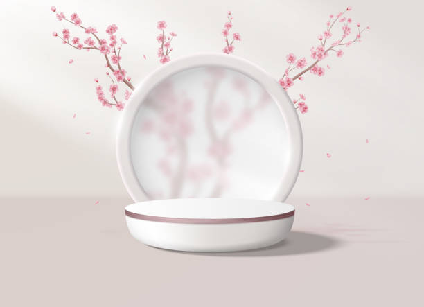 istock Realistic background with a podium in pastel pink colors. Round platform with frosted glass and flowers in the background to display your products. 1995149645