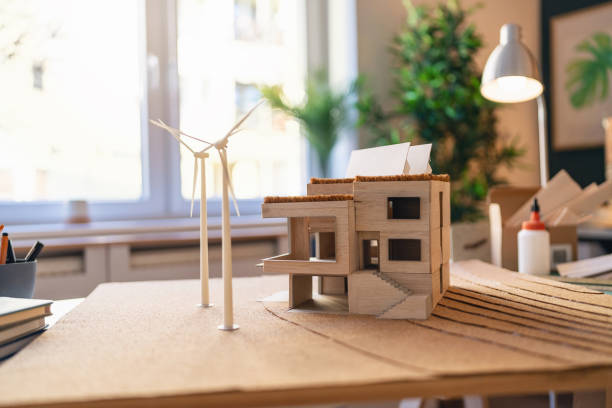 istock Architectural model of a modern house with wind turbines 1995152921